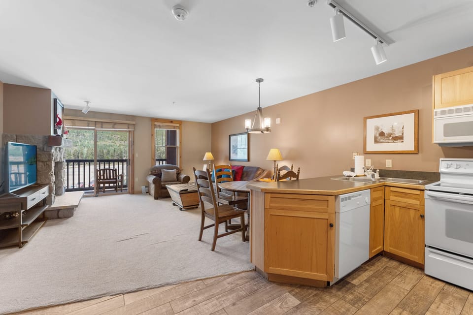 Relax in your spacious open-concept home with modern kitchen, cozy fireplace, and peaceful balcony views.