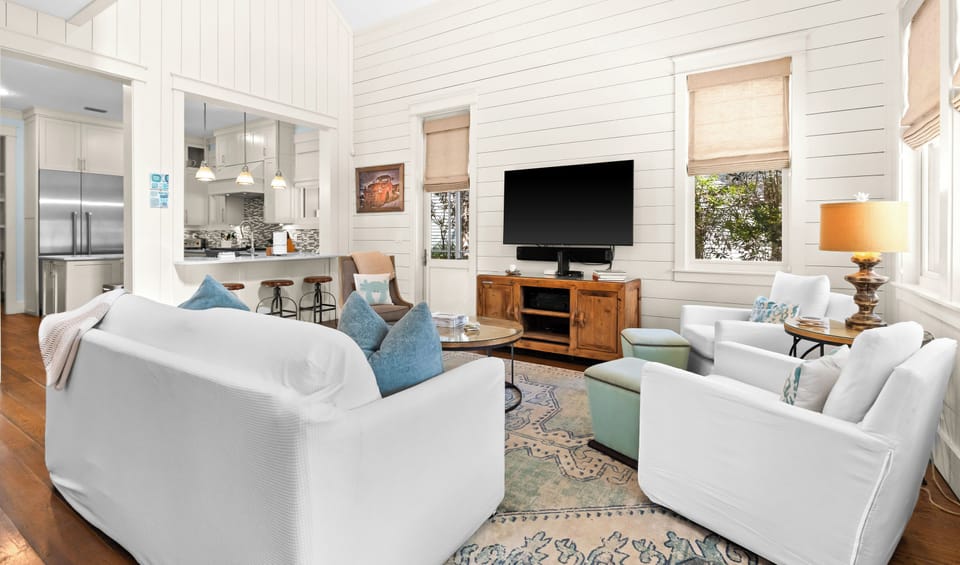Plush seating, modern entertainment, and seamless kitchen views are waiting.