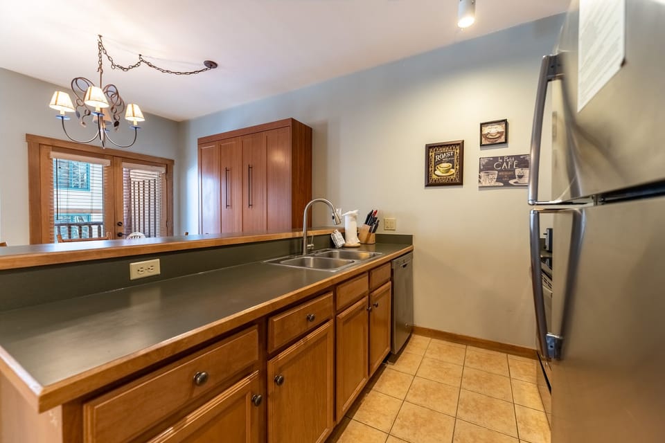 Your fully equipped kitchen awaits with warm wood cabinets, stainless appliances, and everything needed to create delicious meals during your stay.