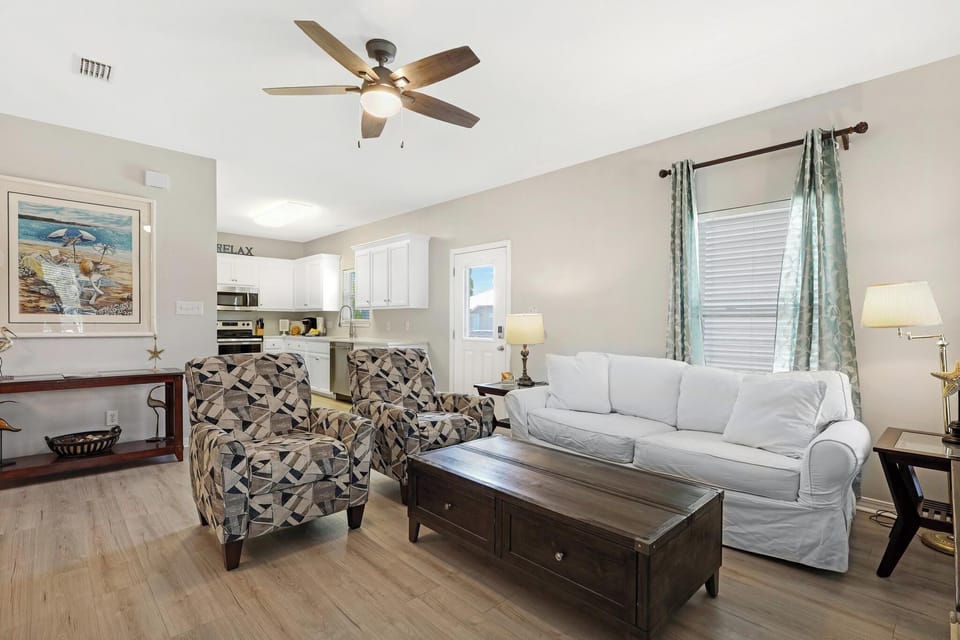 Living Area - The living area is open to both the kitchen and dining areas. This design creates a perfect setting for spending quality time with every member of your group. New, low maintenance flooring has been installed throughout the entire cottage.