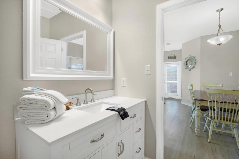 Guest Bathroom - The renovated guest bathroom features a new, single vanity, lighted mirror, and is fully stocked with linens for your stay.