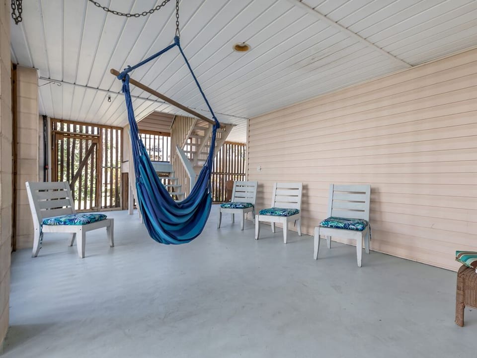 Covered, enclosed patio beneath the home