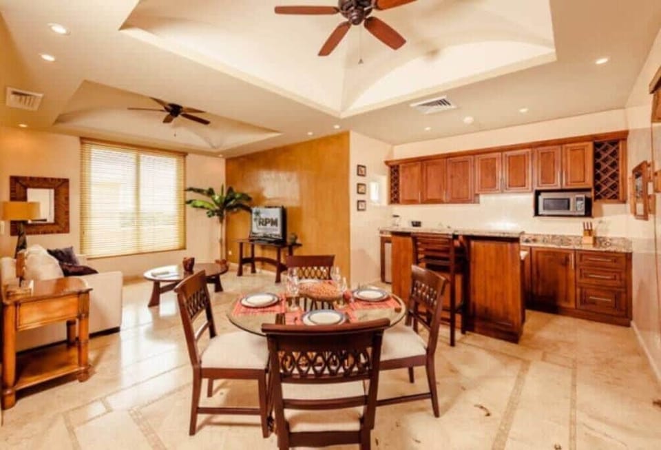 The second floor of this condo has a second kitchen, living area, and dining table. 