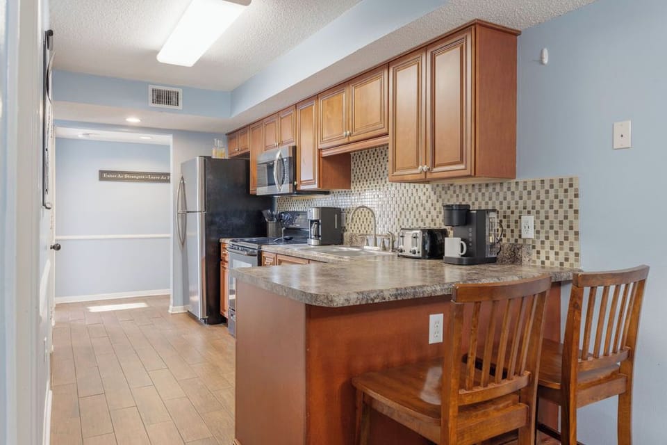 Kitchen - This space is not just a kitchen; it’s a culinary playground, stocked with all the essentials you need for whipping up delicious meals and beachside snacks alike.