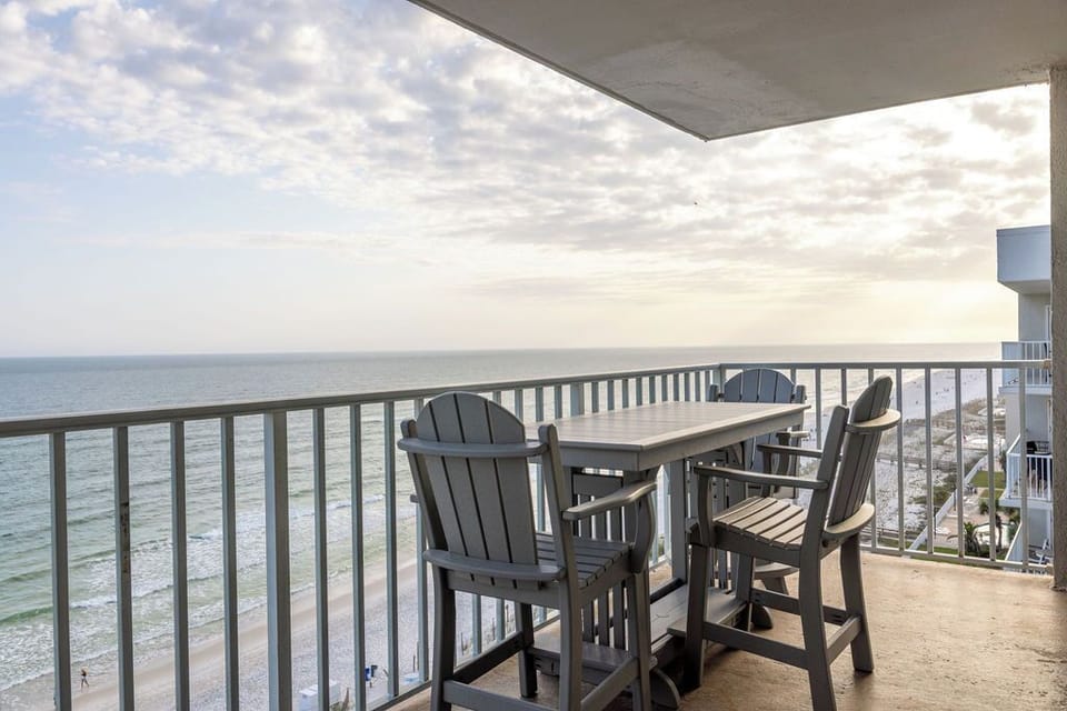 Balcony - Picture yourself on a serene balcony that gazes out over the stunning Gulf of America. This inviting space features a charming table with comfortable seating. With the sun setting in the distance, this balcony transforms into your personal paradise—a delightful retreat that captures the essence of beachfront bliss.