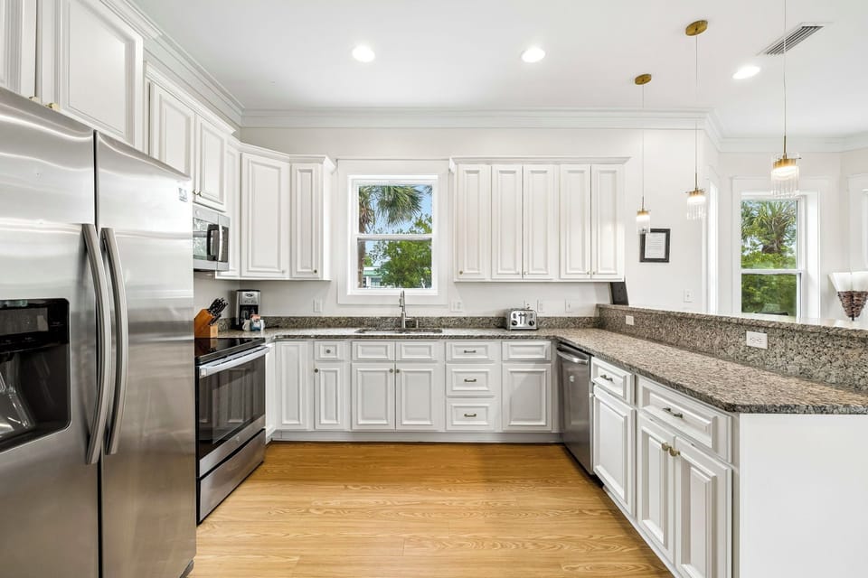 Cook your favorite meals in this bright, fully-equipped kitchen with granite countertops, stainless steel appliances, and tropical views through the windows.