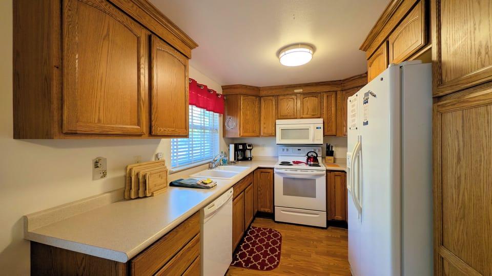 overview of kitchen with dishwasher electric range microwave