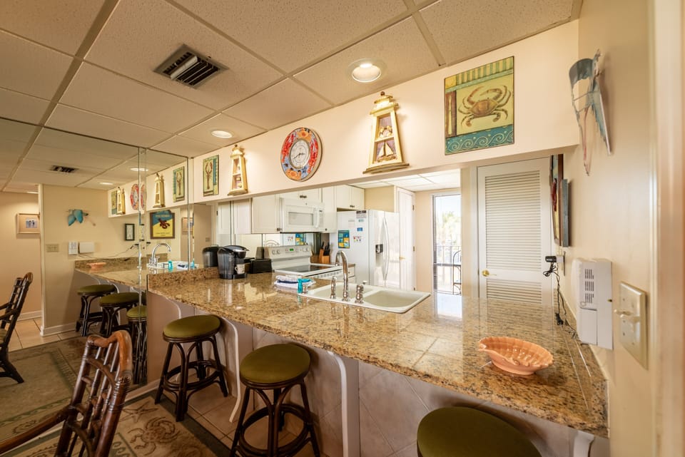 The kitchen has a pass through breakfast bar with barstools for added seating.