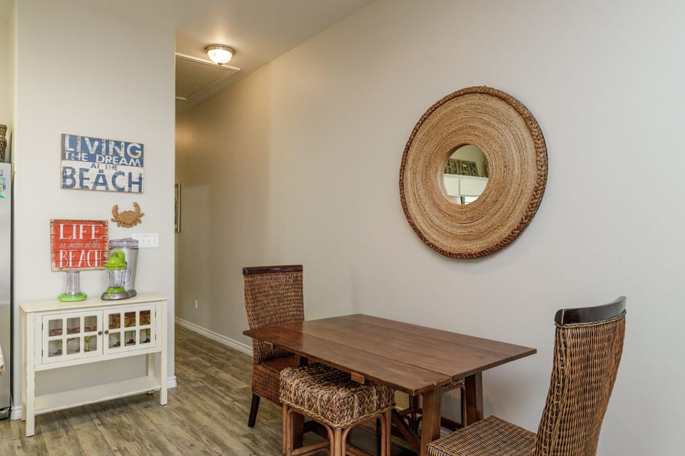 Your cozy dining nook features warm beach-themed decor and comfortable wicker seating for memorable meals together.