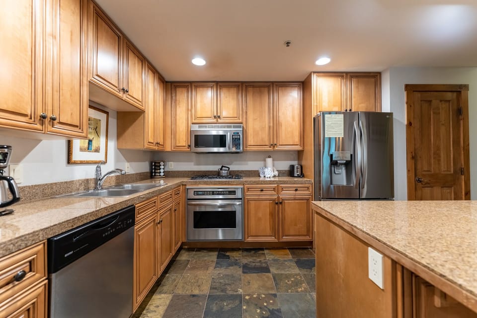 Your gourmet kitchen awaits with warm wood cabinetry, granite countertops, and stainless steel appliances for memorable meal preparation.
