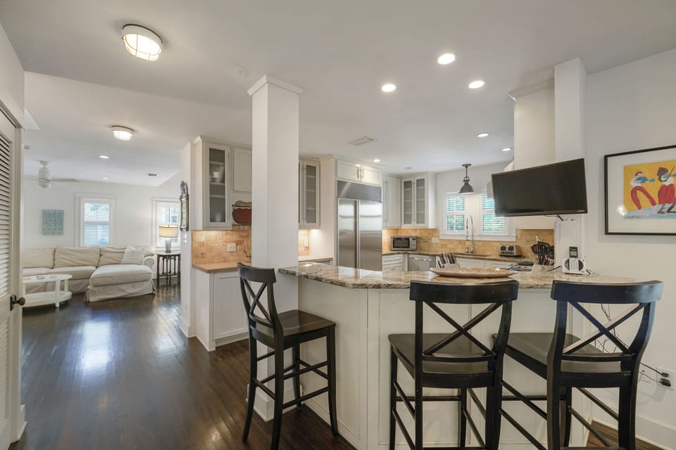 ADJACENT KITCHEN W/BAR SEATING FOR THREE