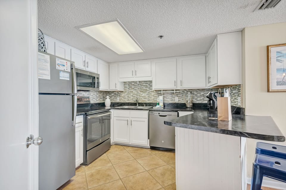 Fully Equipped Kitchen has Stainless Steel Appliances and a convenient Breakfast Bar.