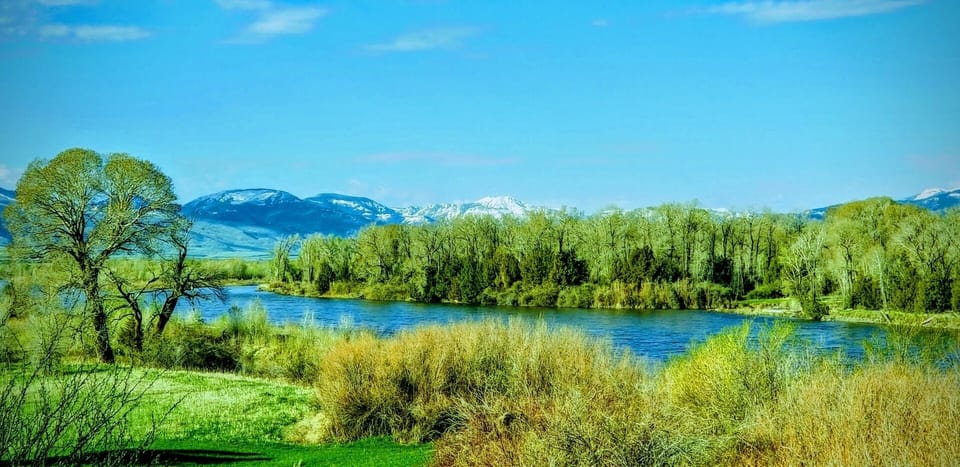 The Yellowstone River meanders past the home with stunning mountain views overhead