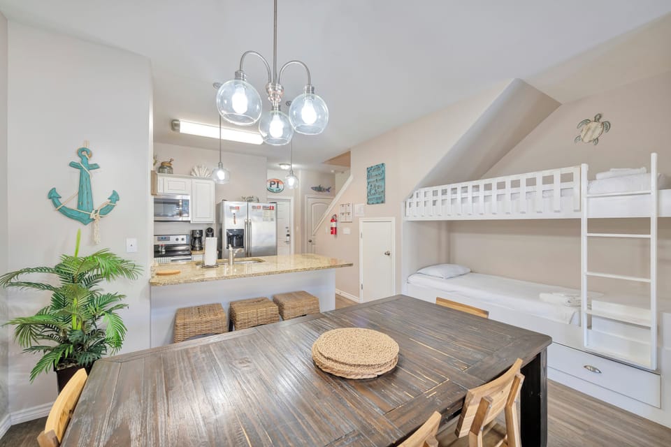 Your beach-themed retreat features a modern kitchen and cozy bunk beds, perfect for family adventures by the sea.