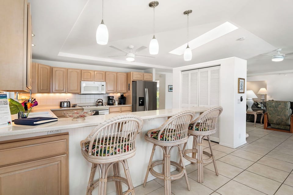 Fully equipped kitchen with a peninsula bar seating for three