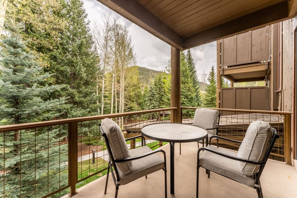 Private balcony with outdoor seating and breathtaking alpine views.