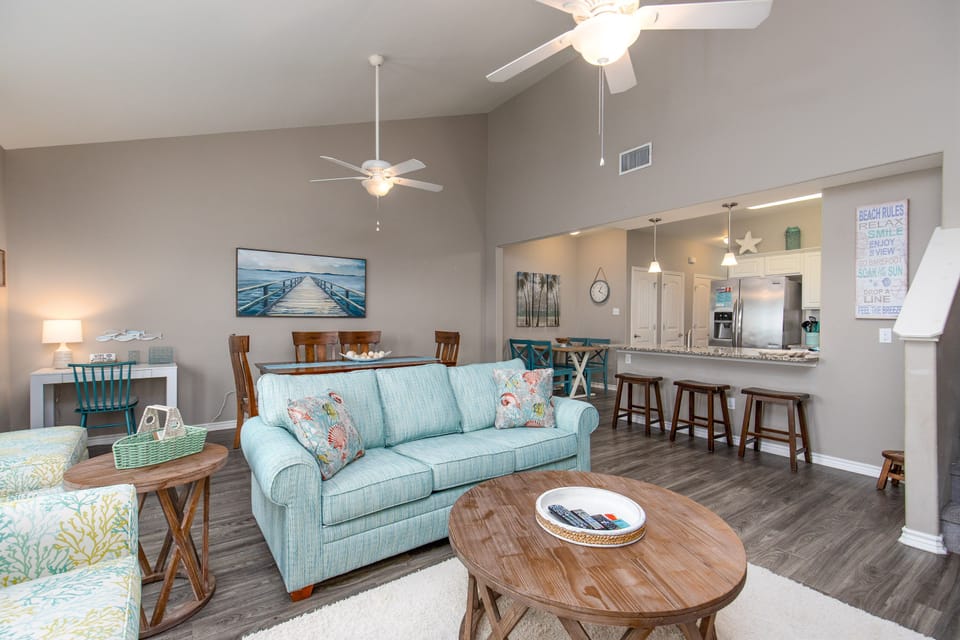 Unwind in your bright open-plan living space with coastal touches and a fully equipped kitchen for memorable vacation meals.