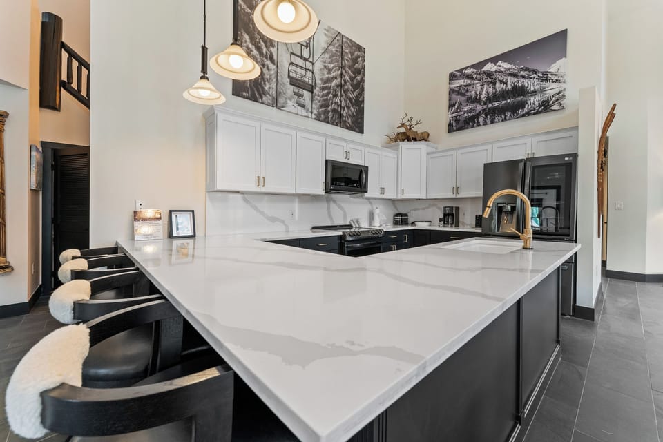Your gourmet kitchen features marble countertops, modern appliances, and cozy bar seating—perfect for morning coffee or evening conversations.