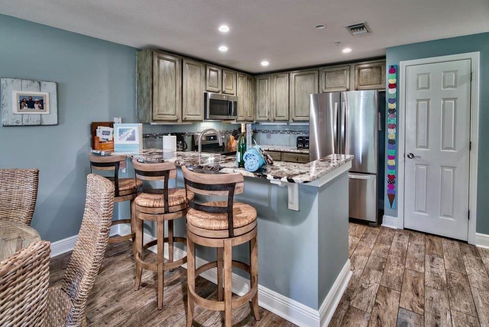 Kitchen area with comfortable barstools - Enjoy the brand new Stainless refrigerator with double doors, pantry with plenty of room for your family's vacation groceries.