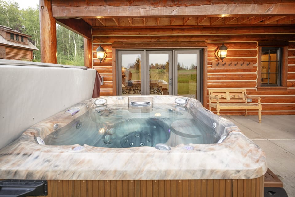 Slip into your private hot tub on the covered deck and let the warm, bubbling water melt away your worries while you soak in views of rolling green fields and forest