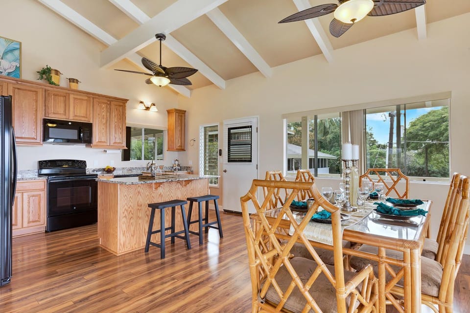 Kitchen and Dining with seating at the dining table and at the kitchen island.