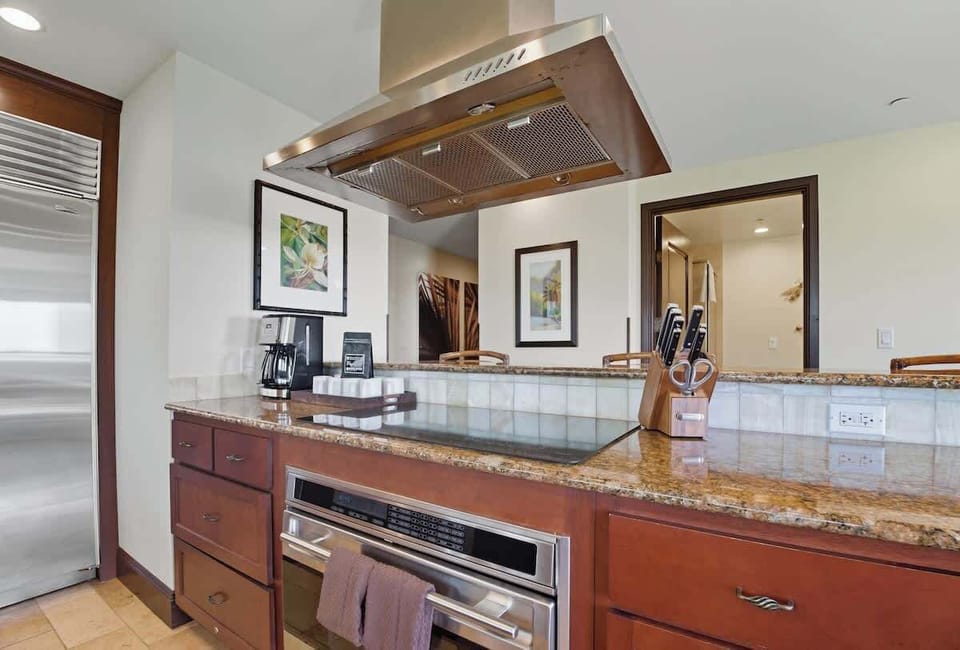 Chef-worthy and fully equipped – Premium appliances, granite countertops, and custom cabinetry make preparing island-fresh meals a dream in this sun-drenched culinary space