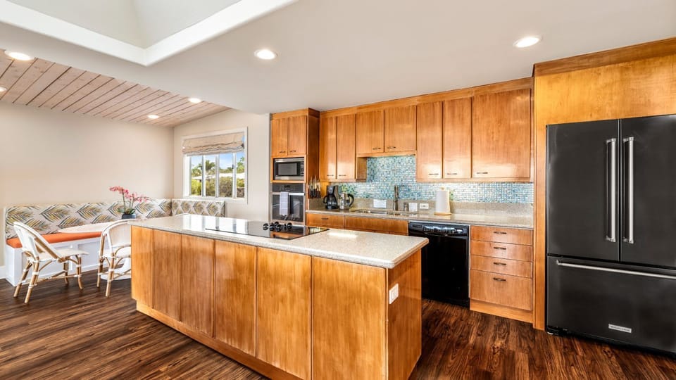 Kitchen flows to bright and joyful breakfast booth