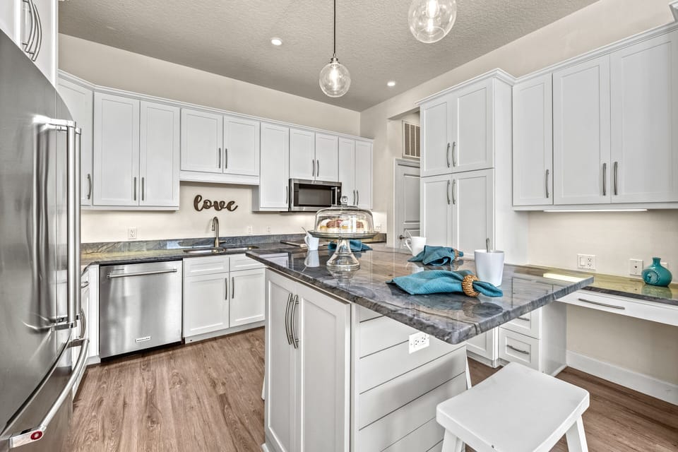 Clean lines, coastal tones, and high-end appliances—this kitchen is equal parts beauty and utility.