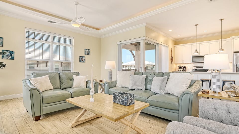 Feel the ocean breeze drift through the living room as sunlight spills in from the balcony, inviting you to unwind indoors and out.