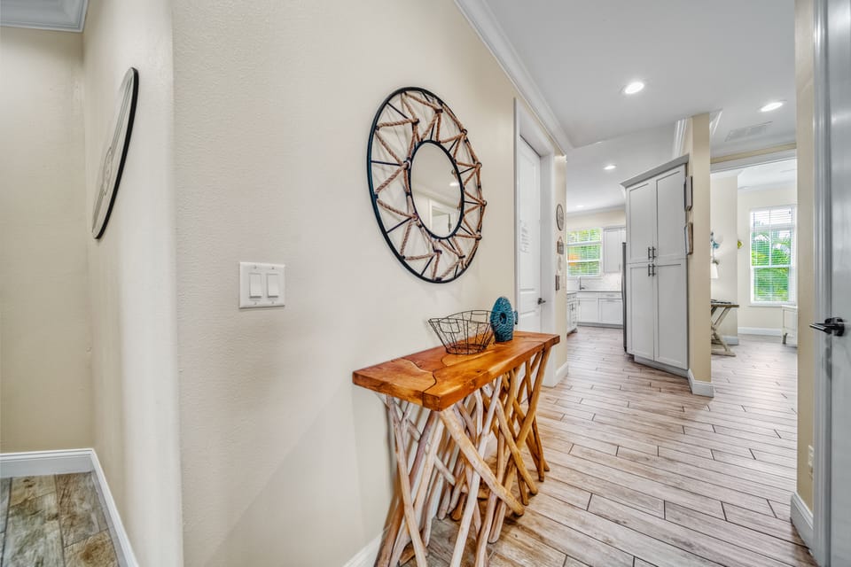 Hallway leading you deeper into the home—calm, coastal tones guide you to the bedrooms for a peaceful night's rest.