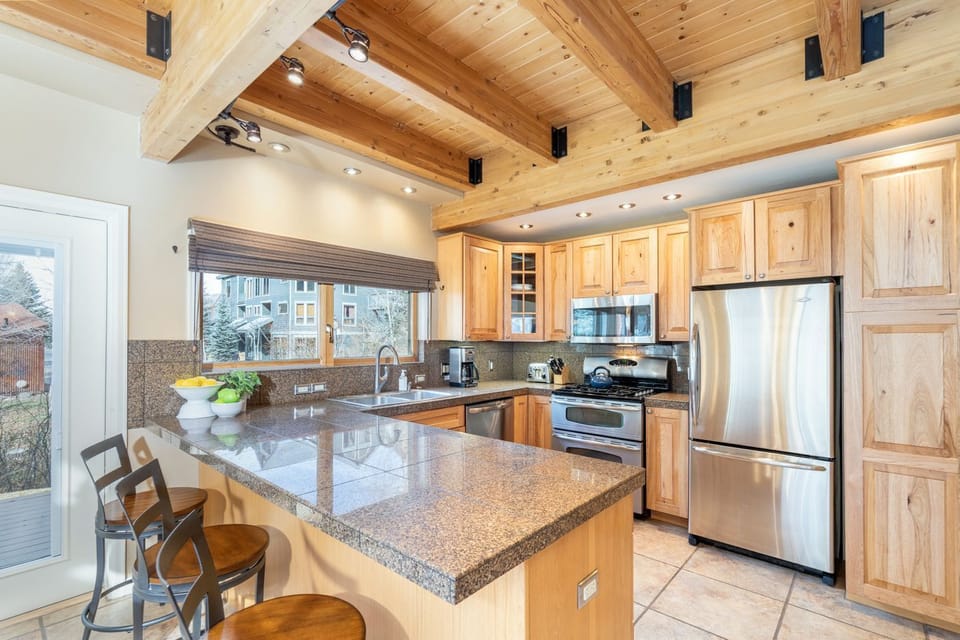 Fully equipped kitchen with island seating for three.
