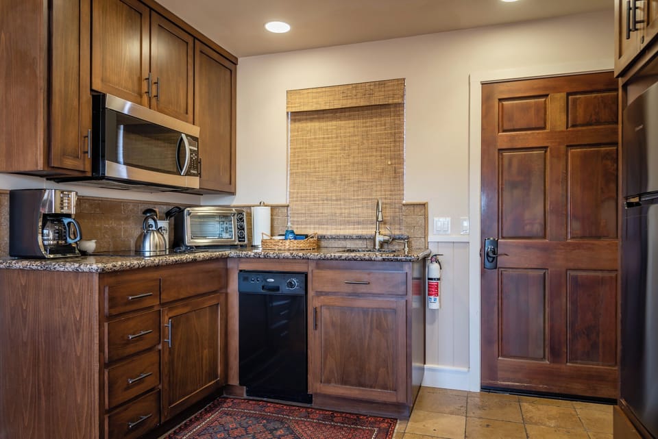 Gather around the prep space with warm wood cabinetry
