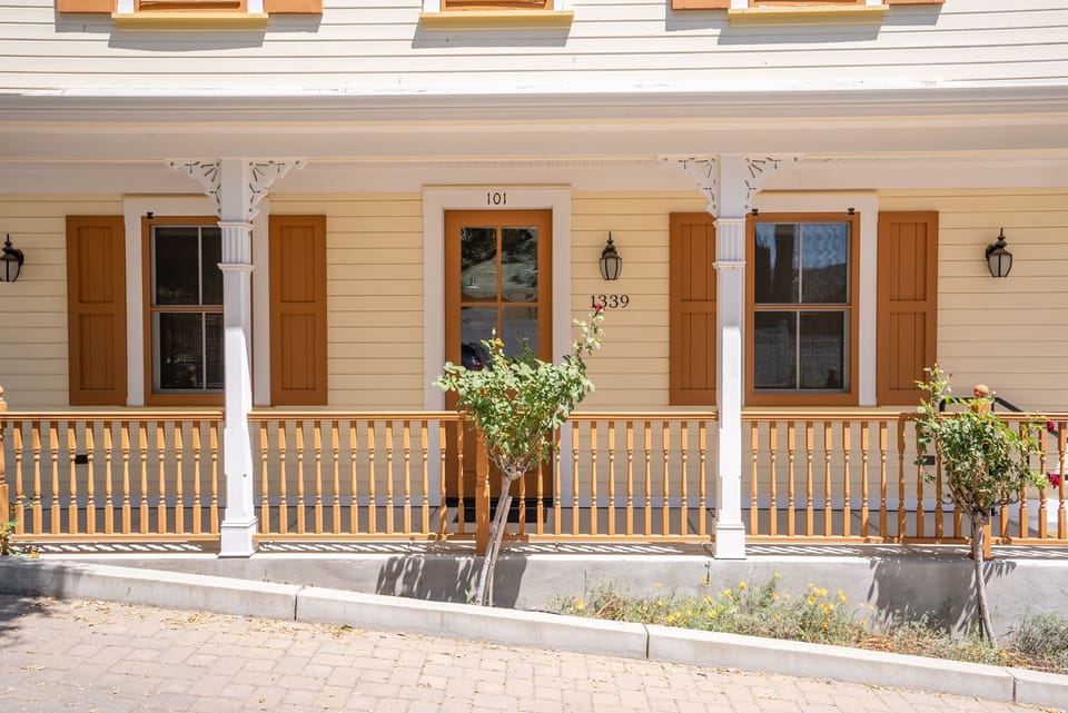 Step out to shaded porch with classic rail details