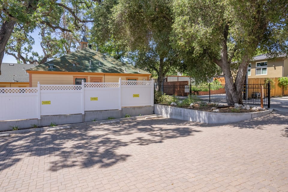 Shaded paver drive gives the home a calm arrival