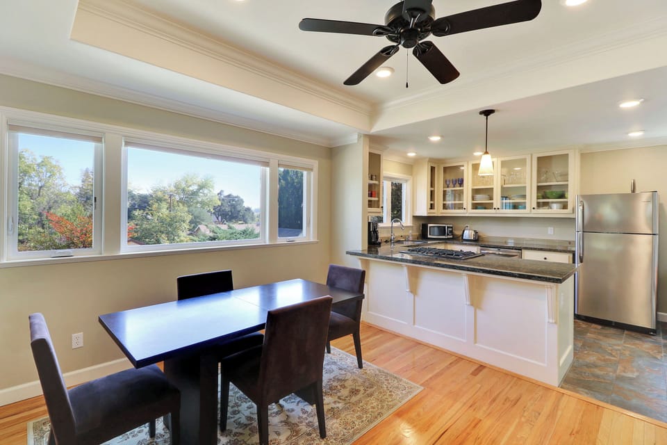 Gather around the dining table by the kitchen