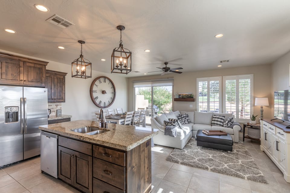 Kitchen View - The living room is conveniently adjacent to the kitchen. There is also access to the back patio which has a BBQ grille suitable for all your favorite BBQ dishes.