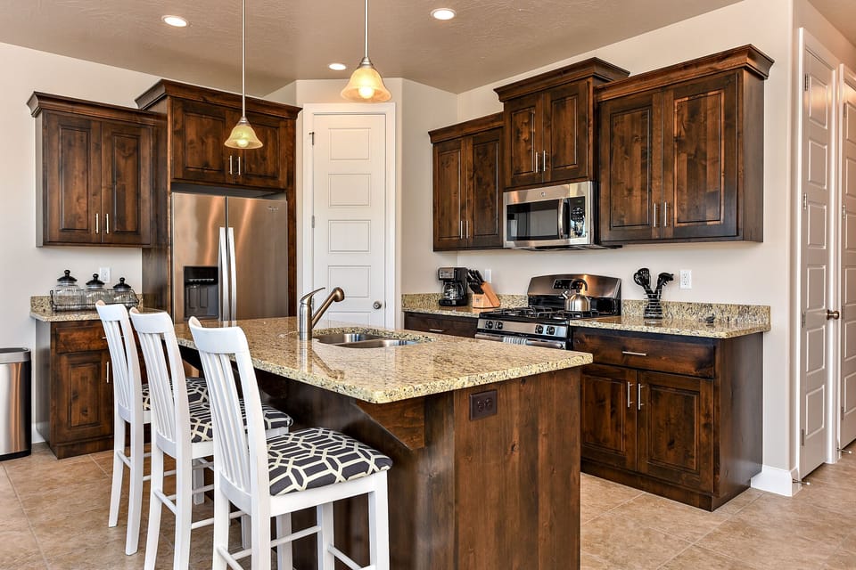 Kitchen - The Kitchen is complete with everything you will need for meal preparations including pots, pans, baking dishes, plates, cups, silverware, cutlery, and an assortment of cooking utensils.