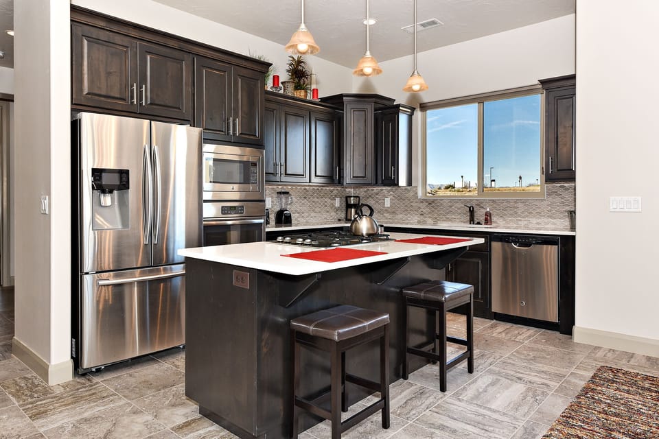 Kitchen - The kitchen is fully stocked with all the dishes, cookware, baking pans, and cutlery you will need for meal preparations and includes stainless steel appliances and granite counter tops.