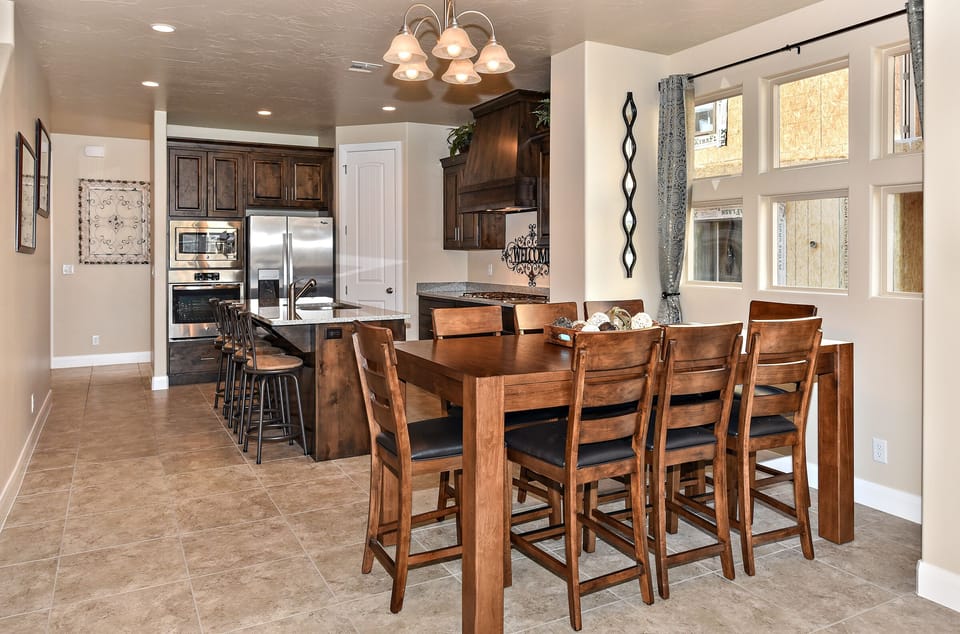 Dining Table and Kitchen - With an open and spacious floor plan, the Dining Room and Kitchen can accommodate meal preparations for groups large or small.
