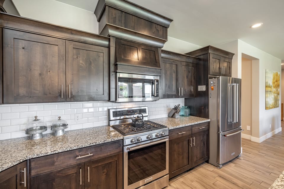 Kitchen - The kitchen is fully stocked with all the dishes, cookware, baking pans, and cutlery you will need for meal preparations and includes stainless steel appliances and granite counter tops.