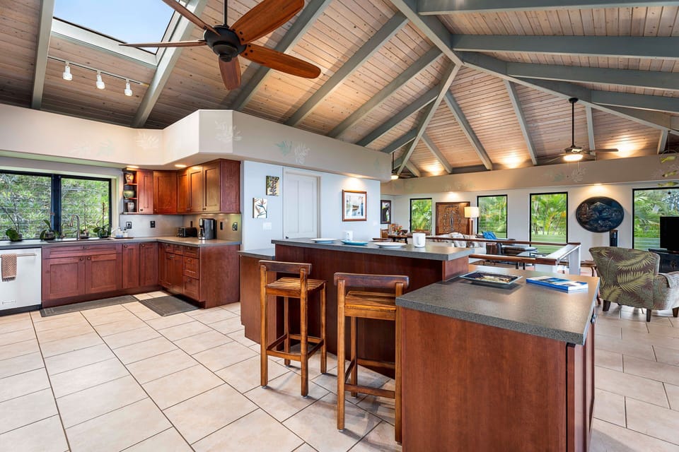 The gourmet kitchen has an island bar, built in desk, skylight and every utensil, vessel, and appliance the gourmet cook needs