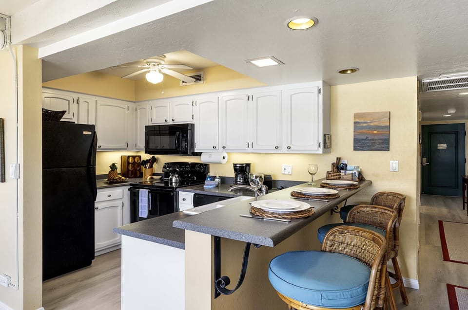 The well stocked kitchen has a breakfast bar