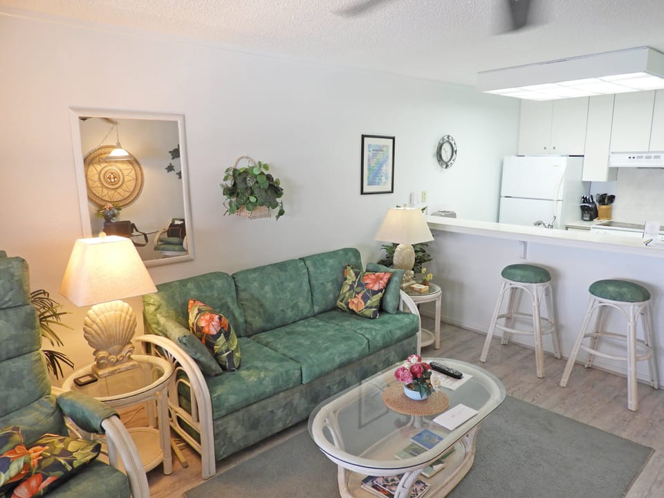 Sofa, coffee table, table lamps, and breakfast bar with seating for two