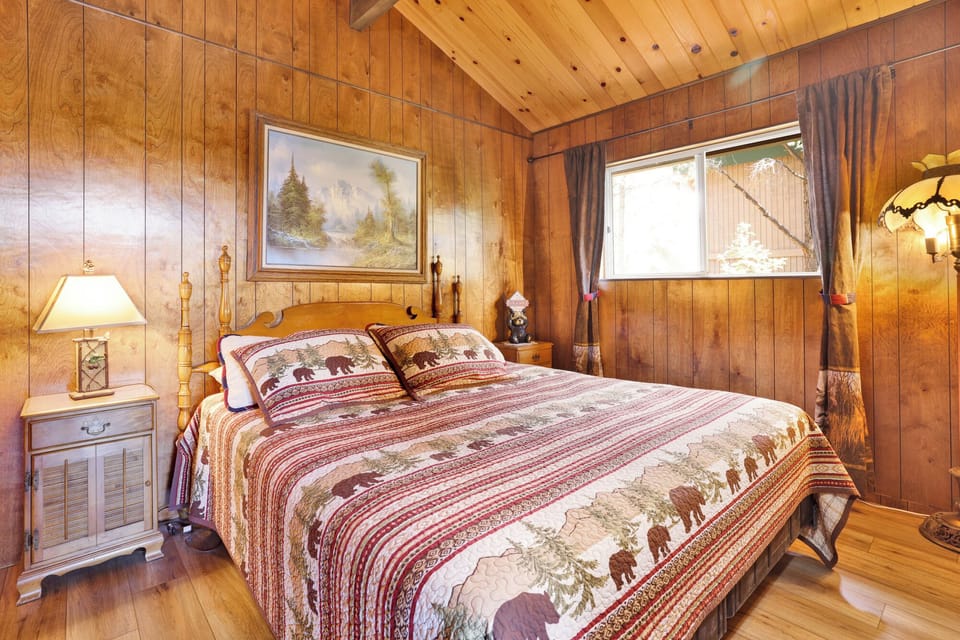 Peaceful cabin bedroom with plush bedding, and beautiful views—ideal for restful nights, cozy mornings, and a relaxing mountain escape.