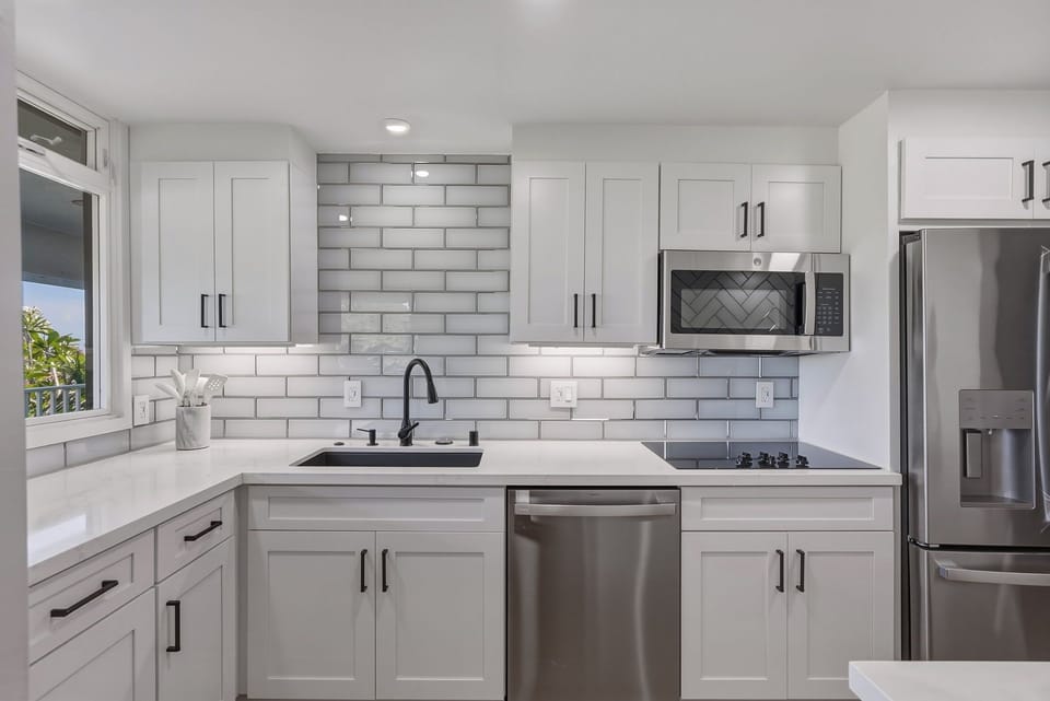 Whip up your favorite island meals in this spacious, sunlit kitchen featuring modern applianced