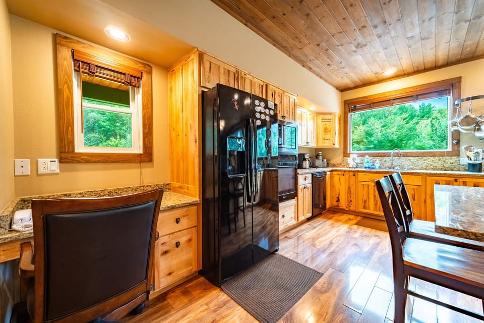 The kitchen features a desk and chair, one of two locations to work remotely at the home.