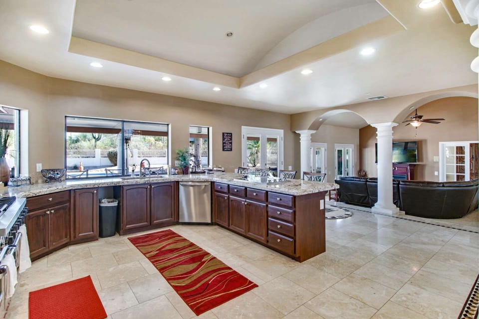 Spacious kitchen with granite counter tops, pass through window and plenty of cupboards
