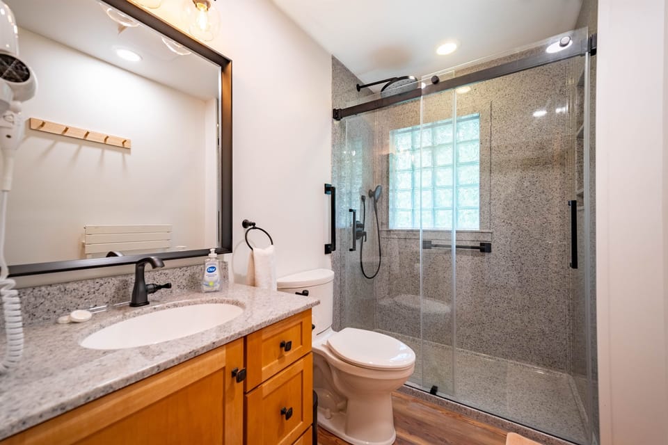 Bathroom 2 on the main floor has a luxurious walk-in rain shower