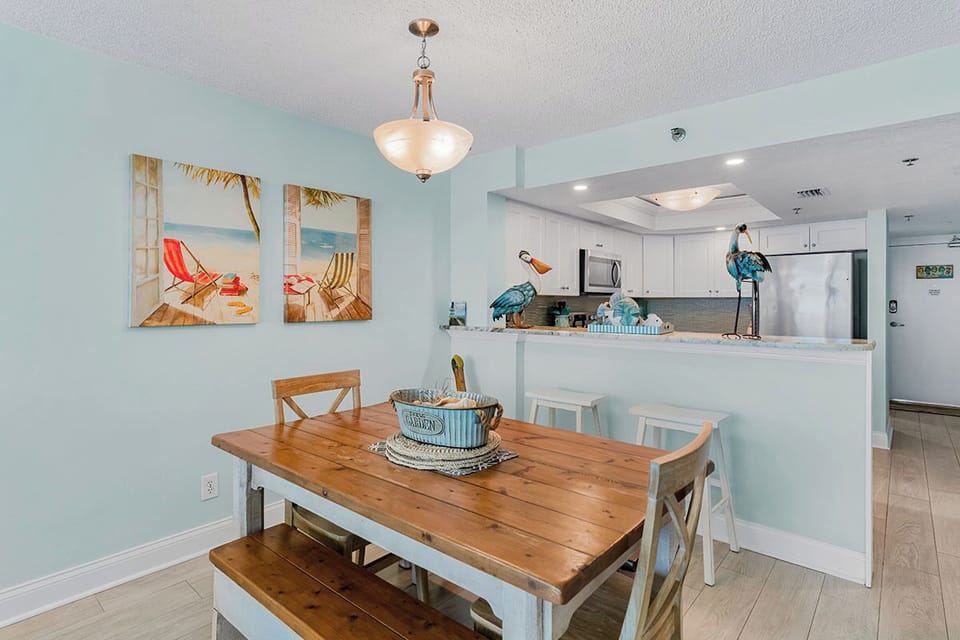 Your bright dining space flows seamlessly into the fully equipped kitchen, perfect for memorable meals with coastal charm.