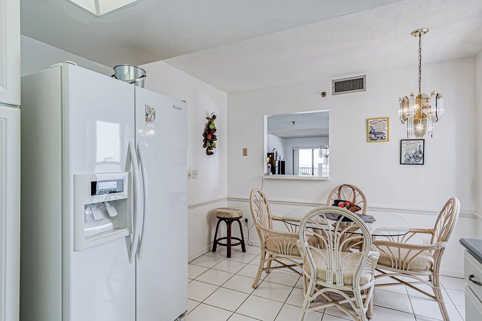 Your bright kitchen and dining area features modern appliances and charming rattan seating where you'll enjoy meals in comfort.